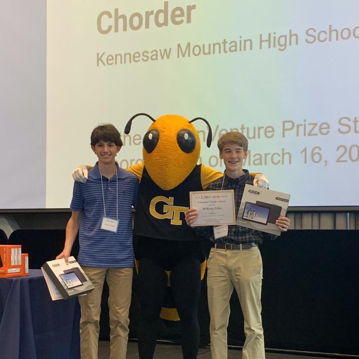 Nathan McKee and William Tyler of team "Chorder" receive the Consumer Goods Award at the K-12 Inventure Prize awards ceremony. They attended the event with their teacher Petrina Baxter.