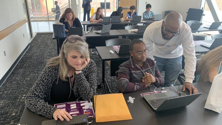 James-Addis Hill (right), web developer and communications specialist at CEISMC, helped a student during the EarSketch workshop.