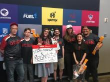 A Georgia Tech VIP class team attending an esports event in Los Angeles in 2019 with Laura Levy (holding the sign).