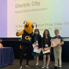 Alexa Duran, Simran Melinamani, and Ben Buzzard of team "Electric City" receive the Energy Award at the K-12 Inventure Prize awards ceremony. They attended the event with their teacher Erica Oakhill.